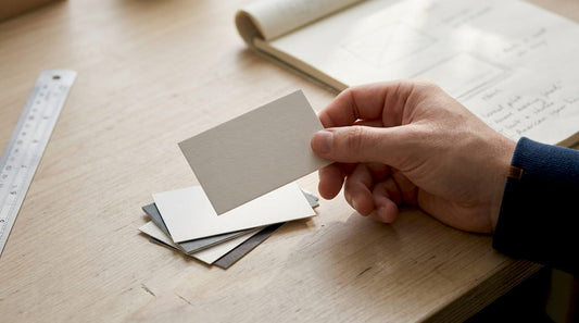 Designer examining premium business card at desk