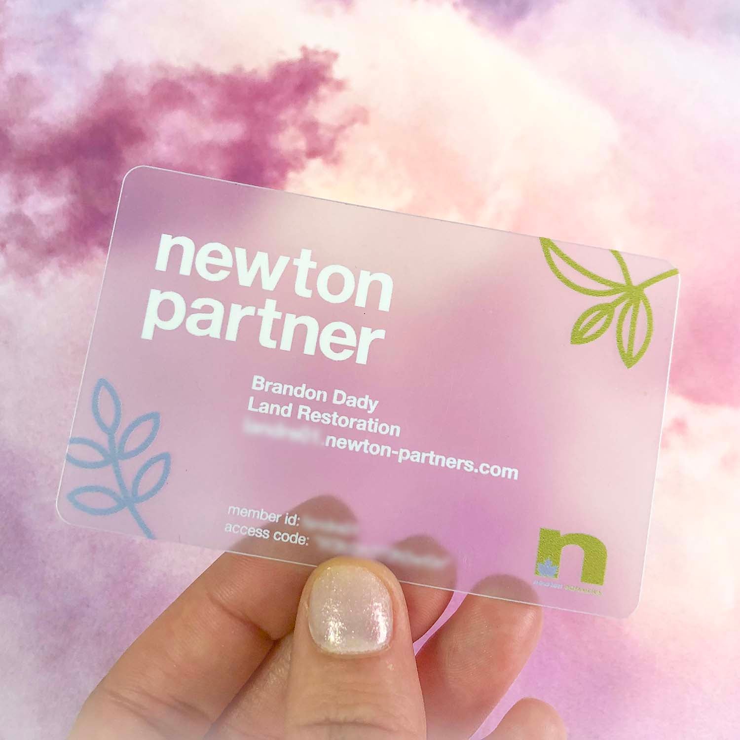 Clear Frosted card held by a hand with a soft pink and purple background. Variable data