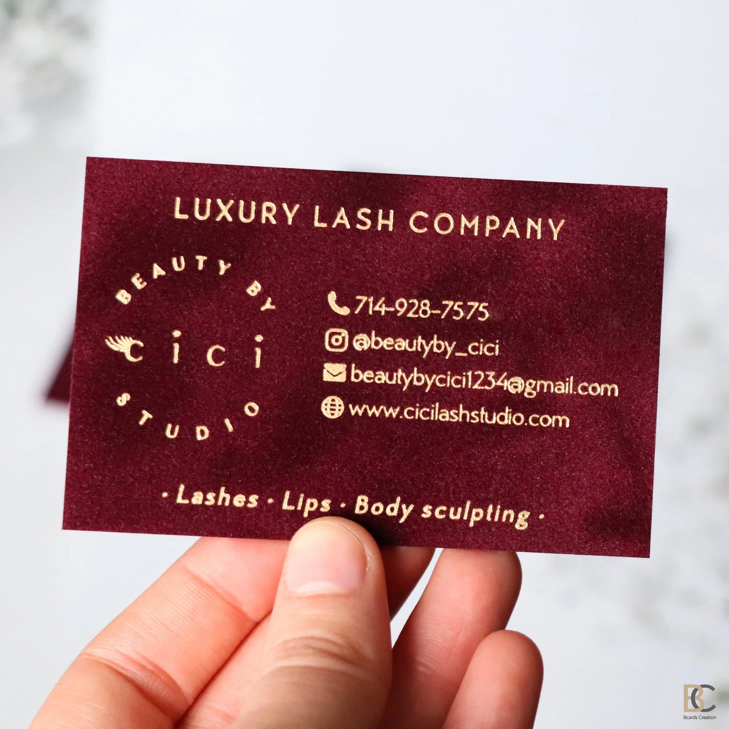 Red velvet multilayer business cards with luxury gold foil stamping. Thick 800 gsm flocked paper with a rich lint texture and elegant gold logo design